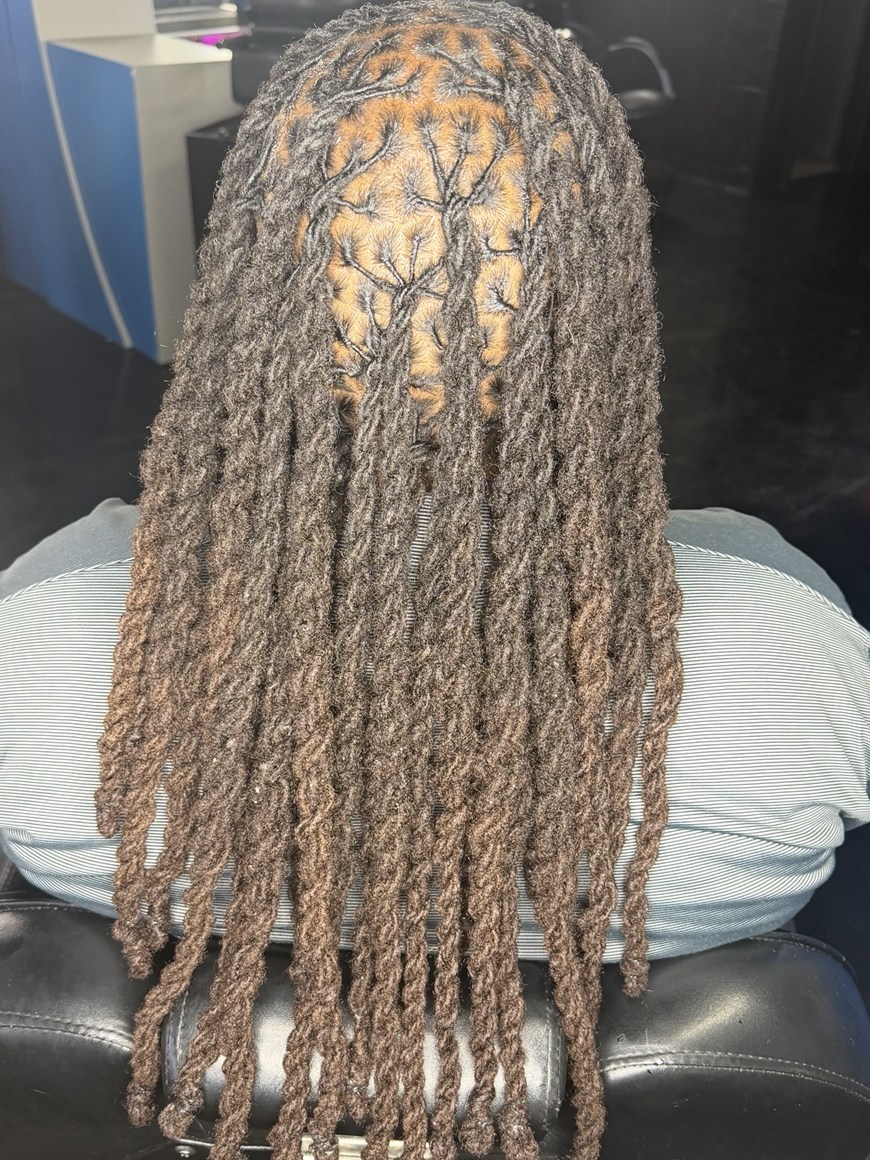 Long locs straight after a full head retwist, falling in even, well-kept rows down the back